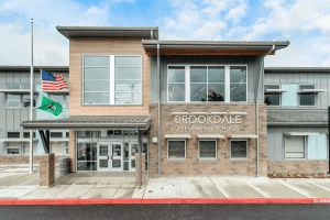 Exterior entrance of Brookdale Elementary School in Naperville, featuring the school sign and brick facade.