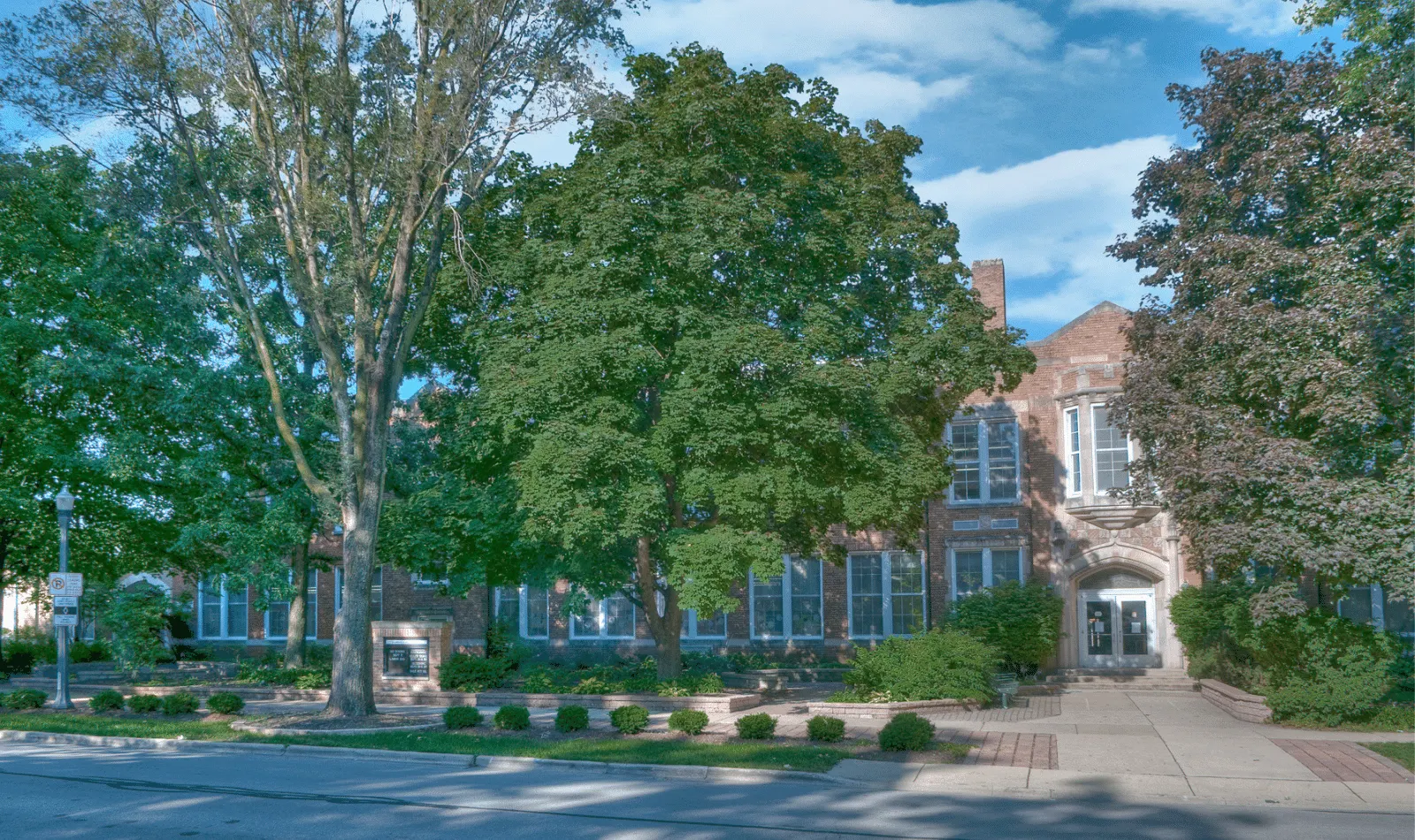 Exterior of Ellsworth Elementary School in Naperville, Illinois with historic brick building and mature trees