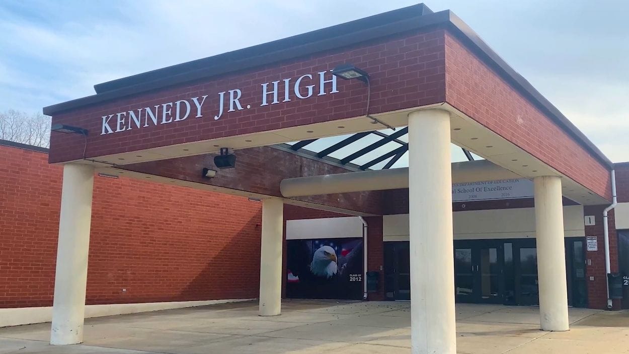 Exterior entrance of Kennedy Junior High School in Naperville, Illinois with covered walkway and columns