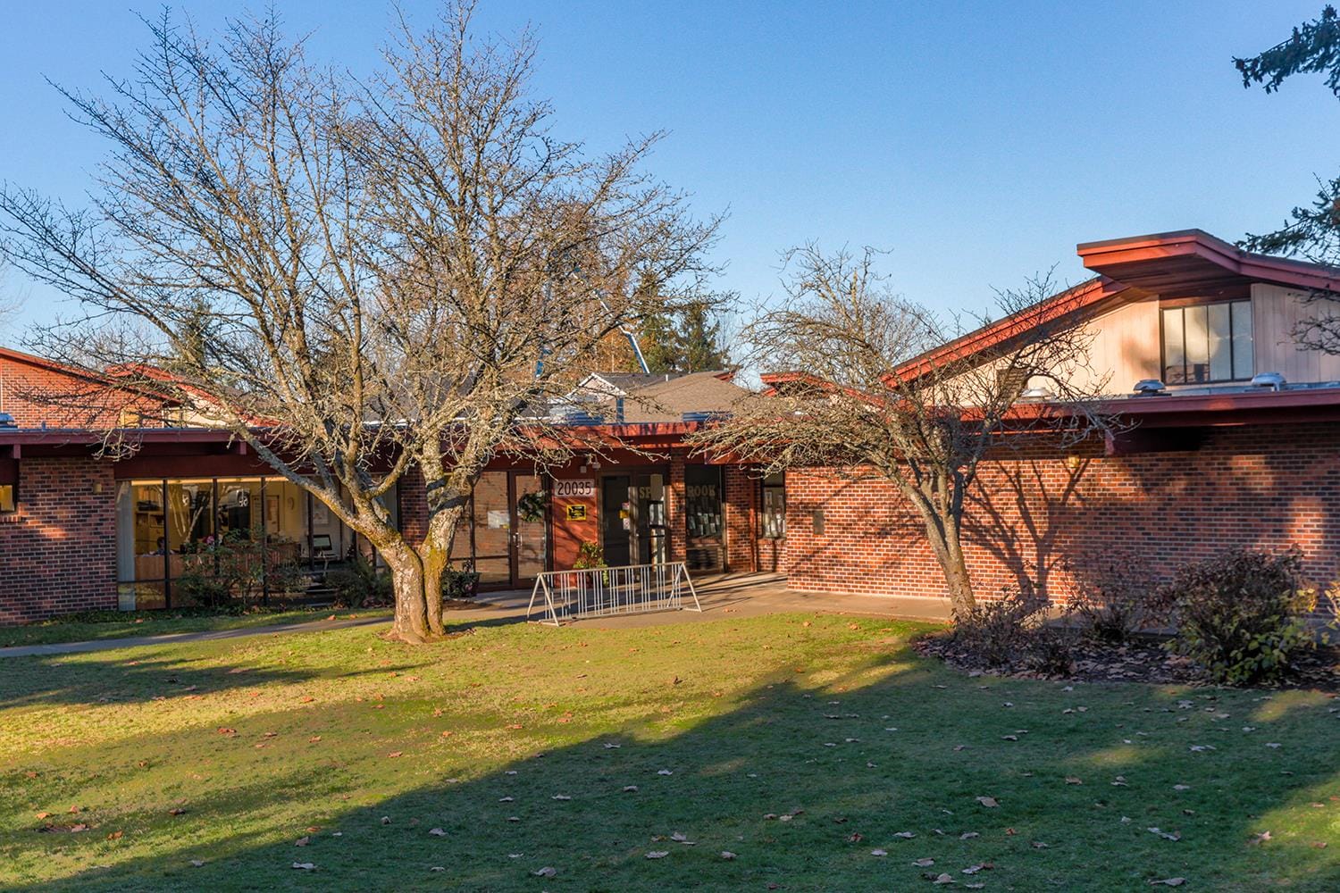 Exterior of Spring Brook Elementary School in Naperville, featuring the brick facade and mature trees.