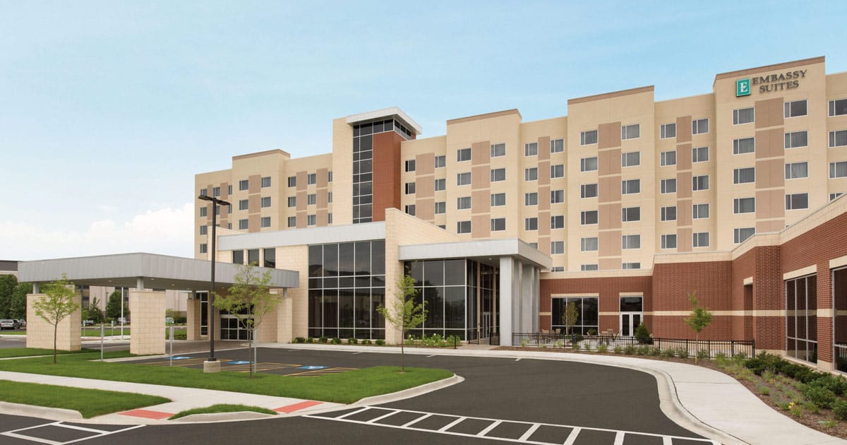 Embassy Suites Naperville hotel exterior with covered main entrance and drop-off driveway