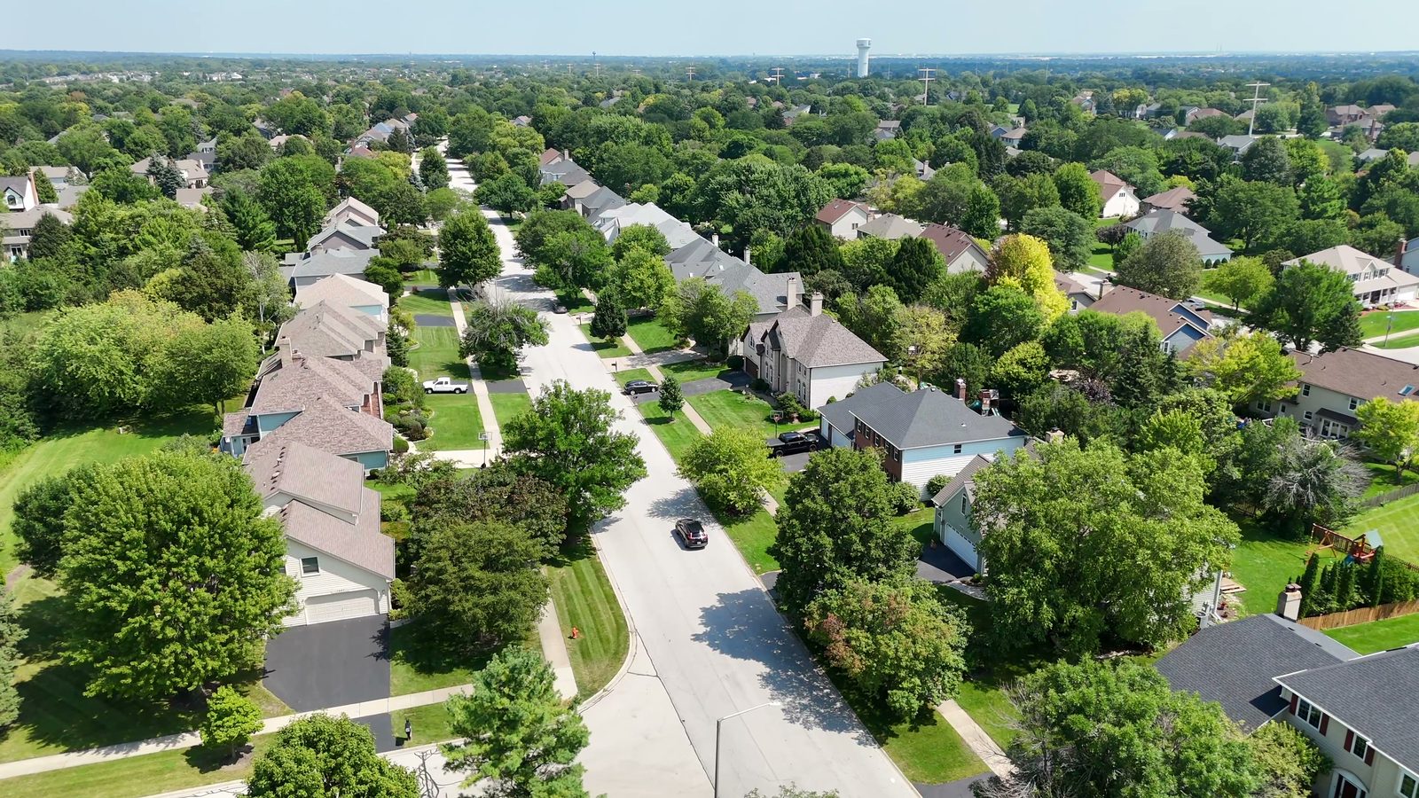 How Many Homes Are in the Ashbury Subdivision in Naperville? 2 Aerial view of tree-lined street and two-story homes in Ashbury subdivision Naperville 2026