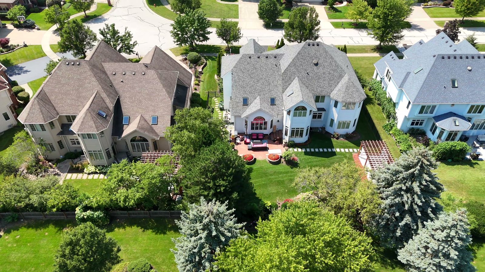 How Many Homes Are in the Ashbury Subdivision in Naperville? 3 Close aerial view of two-story homes and landscaped backyards in Ashbury Naperville 2026