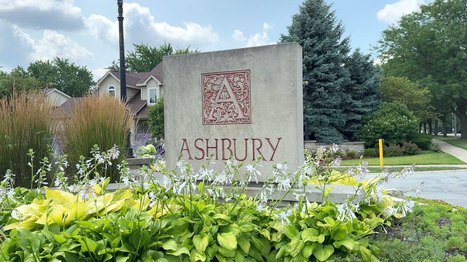 How Many Homes Are in the Ashbury Subdivision in Naperville? 4 Ashbury stone entrance monument sign with two-story homes behind it in Naperville 2026