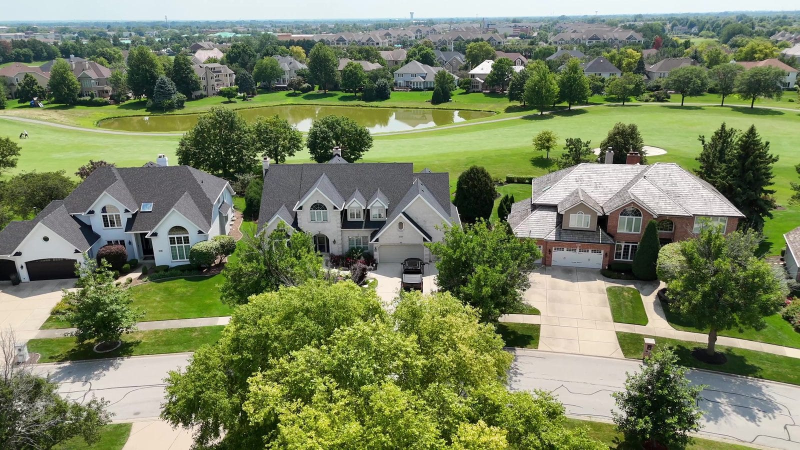 Buying a Foreclosure or Short Sale in Naperville: How Each One Works 1 Buying a bank-owned home: aerial of three Naperville homes beside a golf course