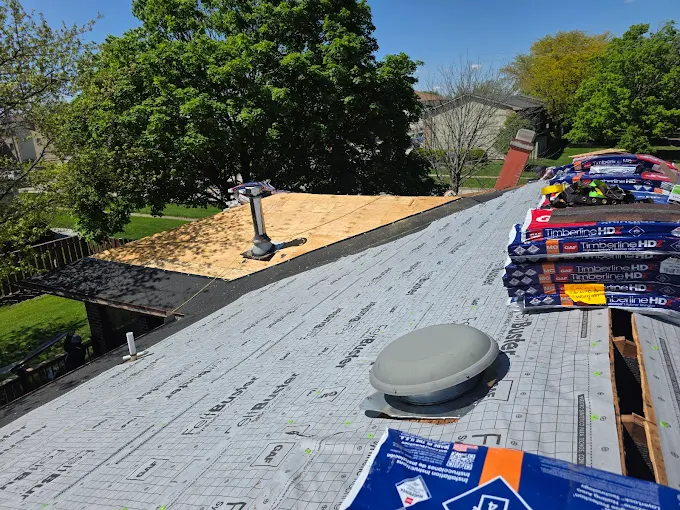 Roof underlayment and asphalt shingles being installed during a Casey Roofing Contractor project in Naperville, Illinois.
