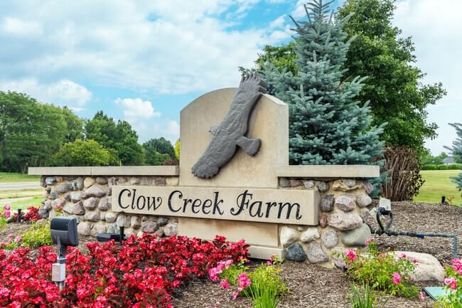 Neighborhoods 10 Clow Creek Farm neighborhood entrance sign with landscaping in Naperville Illinois