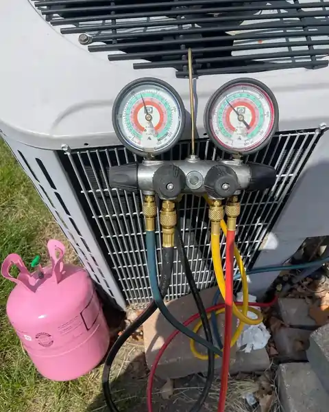 AC diagnostic gauges connected to an outdoor air conditioning unit for CPR Heating & Cooling Inc service in the Naperville area.