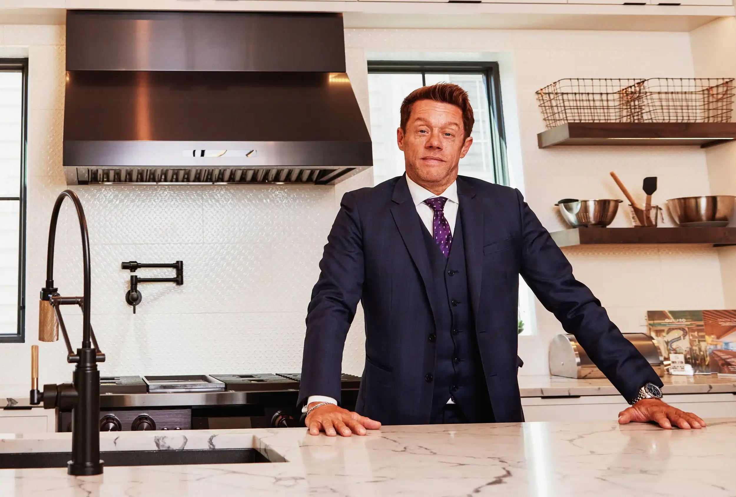 Dan Firks standing in a modern luxury kitchen in a Naperville home