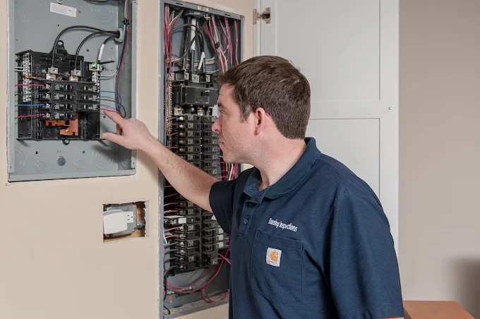Dunsing Inspections inspector checking an electrical panel during a home inspection near Naperville Illinois