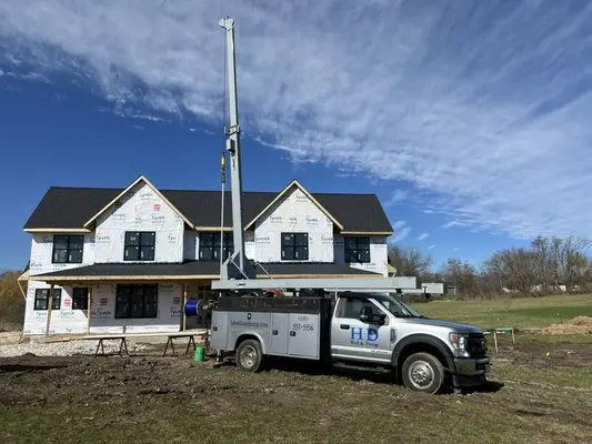 DuPage Pump Inc service truck providing pump and plumbing support at a new construction property near Naperville Illinois