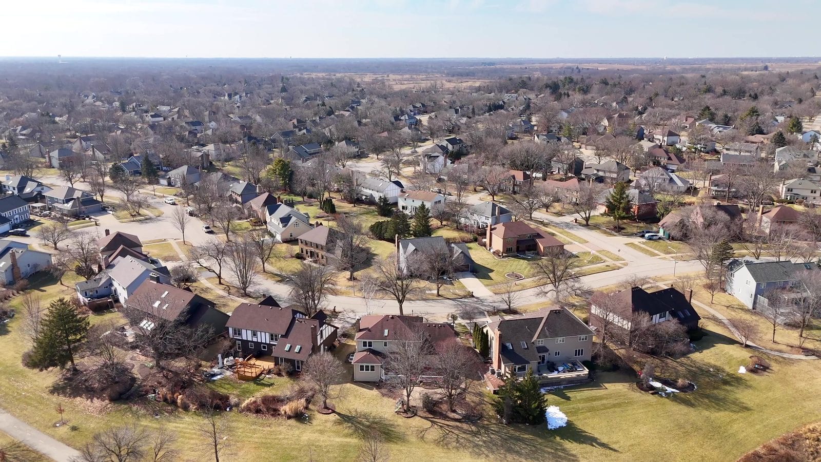 Winter aerial of Naperville homes on curving streets, school district lookup by address