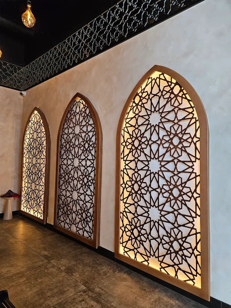 Three backlit Islamic geometric arch panels inside Haraz Coffee House near Naperville Illinois 2026