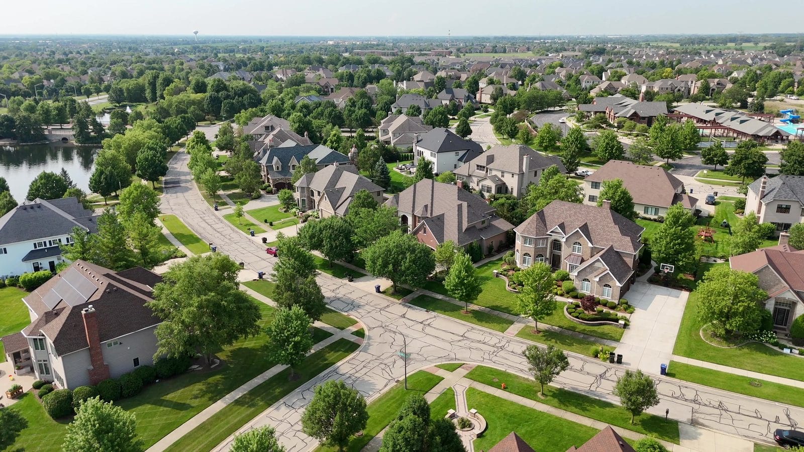 Selling a House With a Lien in Naperville: HELOCs, Payoffs, Releases 3 How to sell a house with a lien: aerial of Naperville homes near a pond