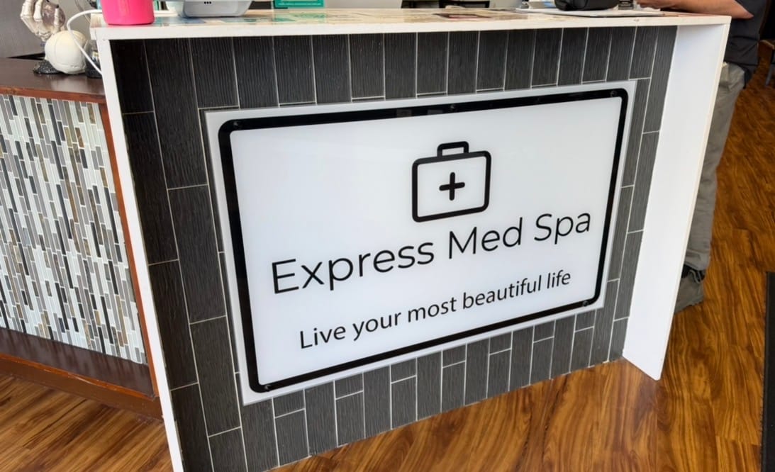 Reception desk inside Express Med Spa La Grange med spa location with modern interior design and branding