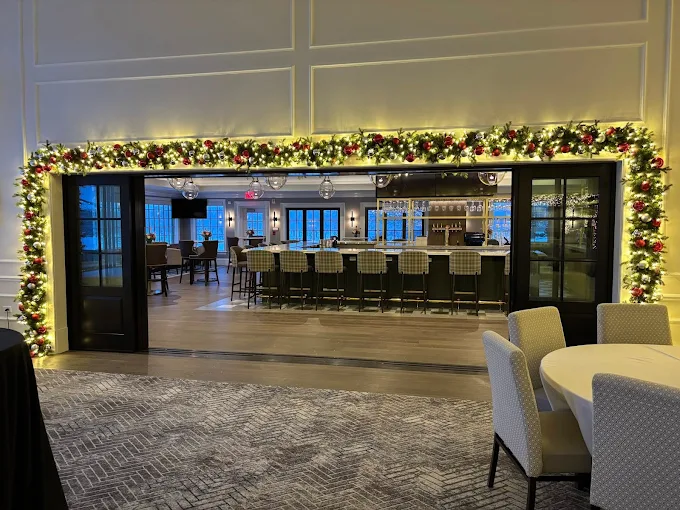Lightville indoor holiday display in Naperville with garland, Christmas lights, ornaments, and bar seating.