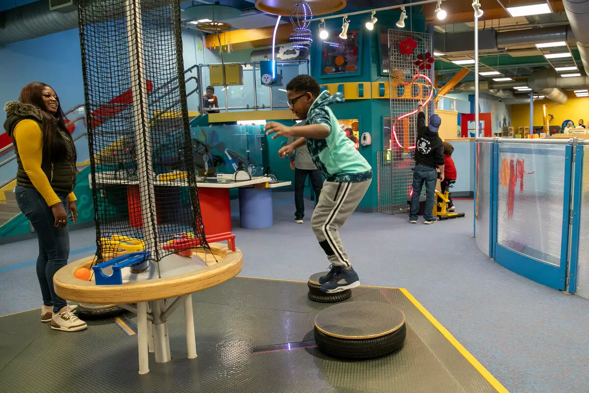 Children explore an interactive indoor exhibit at a childrens museum in Naperville, Illinois, highlighting family activities, hands on learning, and things to do in Naperville