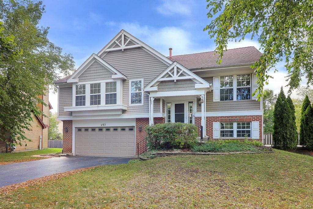 Neighborhoods 7 Two story home with attached garage and gray siding in Naperville Country Estates neighborhood in Naperville Illinois