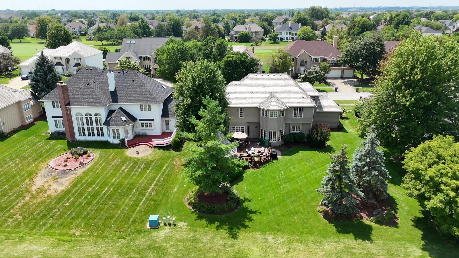 Designated vs dual agency: aerial of two neighboring White Eagle homes in Naperville
