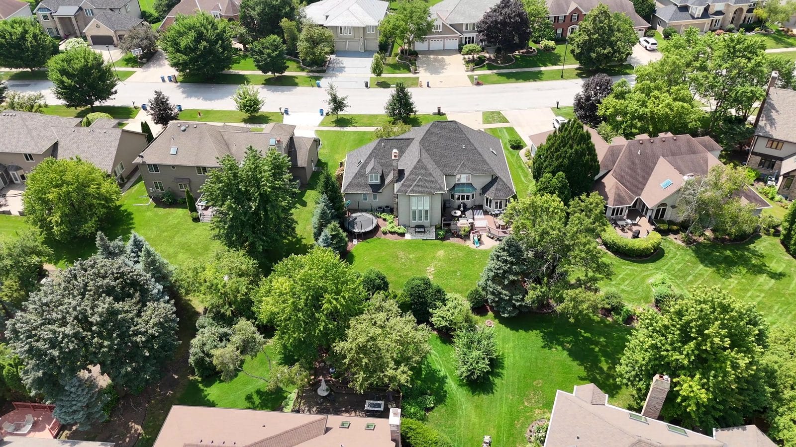 Drone view of a Naperville house roof, chimney, siding and deck that home inspectors check