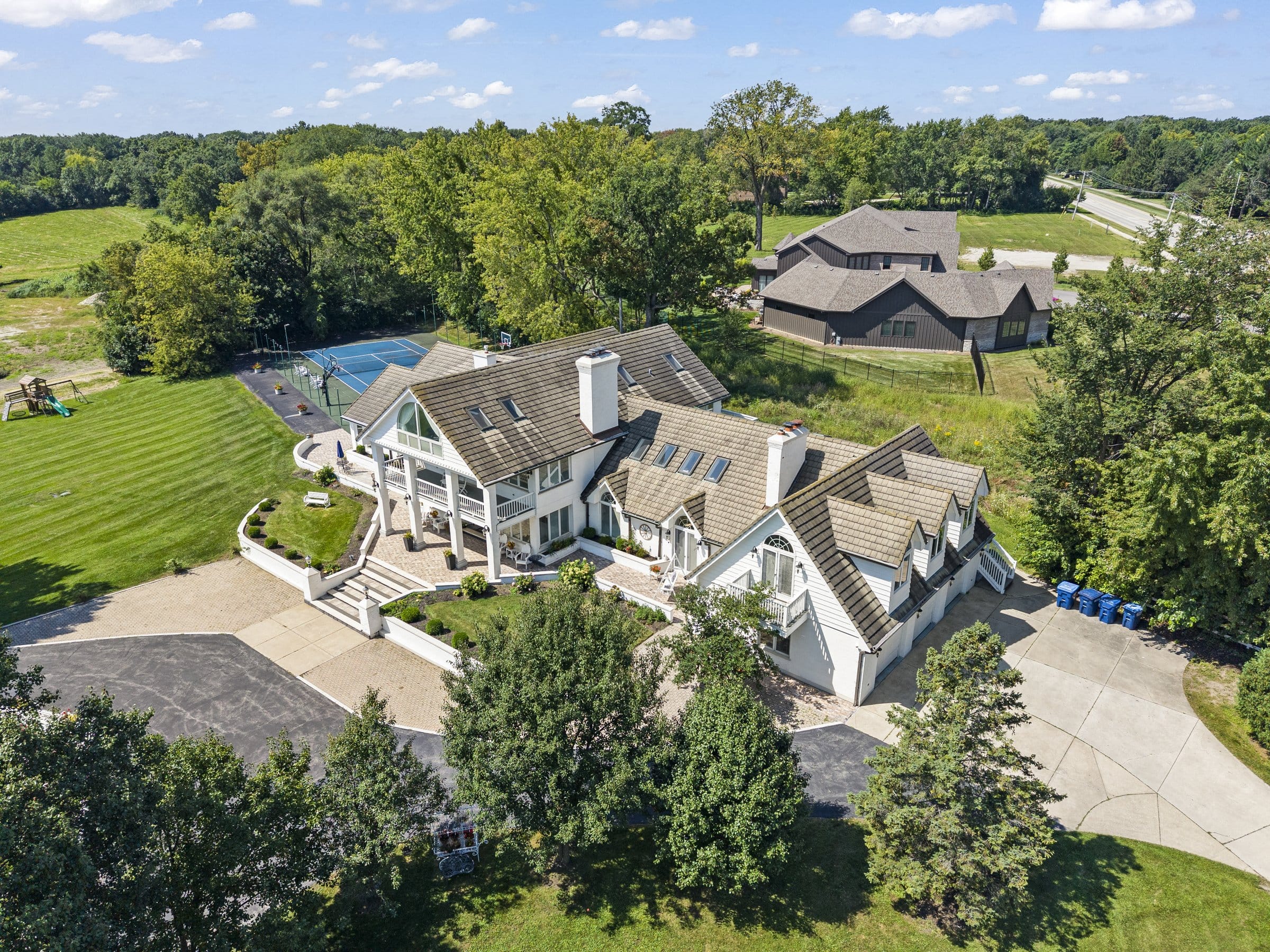 Naperville Luxury Home for Sale: 23W735 Hobson Road, a 2.65-Acre Estate with Indoor Pool and Tennis Courts 3 Aerial view of the 2.65 acre Naperville estate with tennis court and pool wing