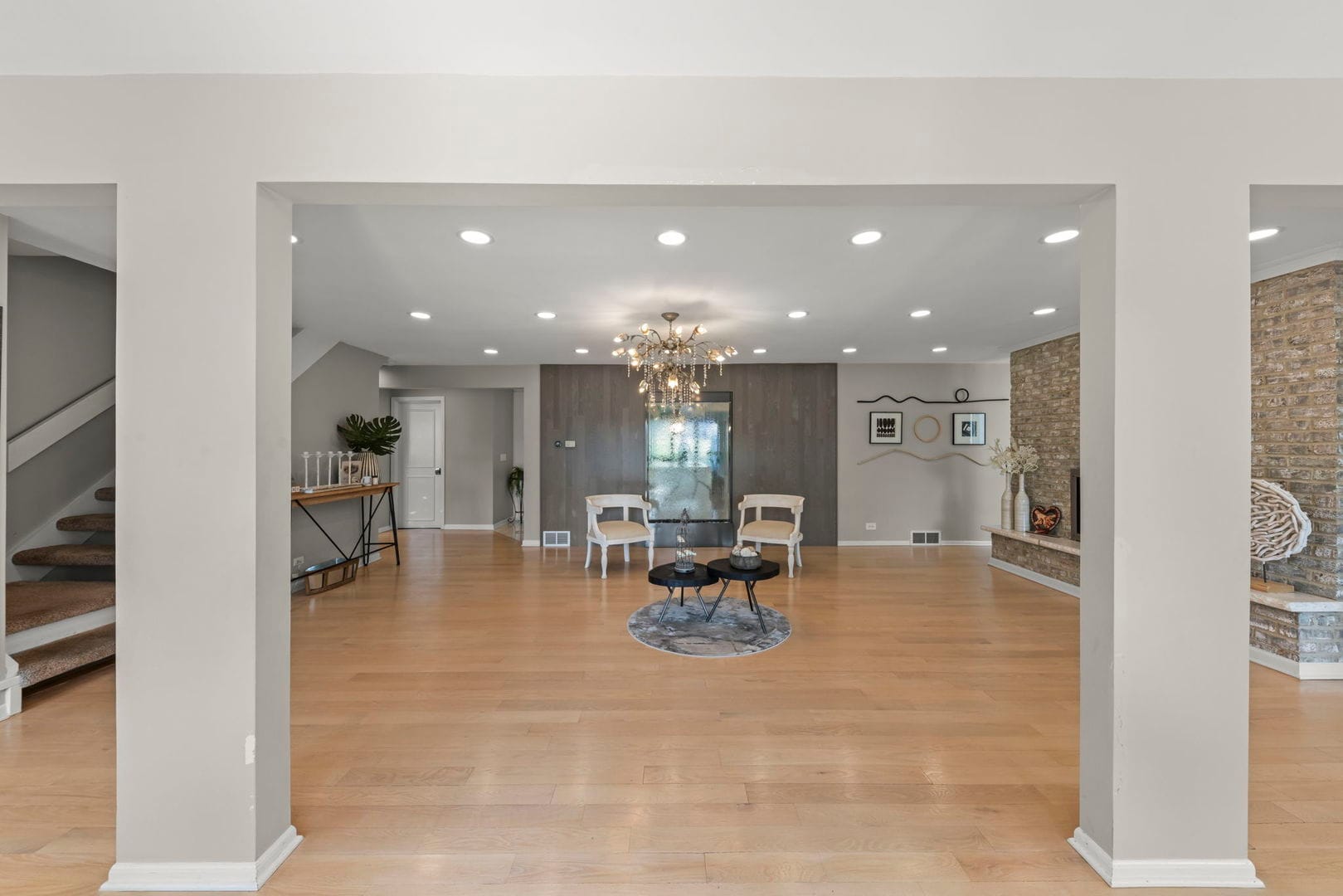 Naperville Luxury Home for Sale: 23W735 Hobson Road, a 2.65-Acre Estate with Indoor Pool and Tennis Courts 7 Open foyer with chandelier, light wood floors and staircase at 23W735 Hobson Rd Naperville