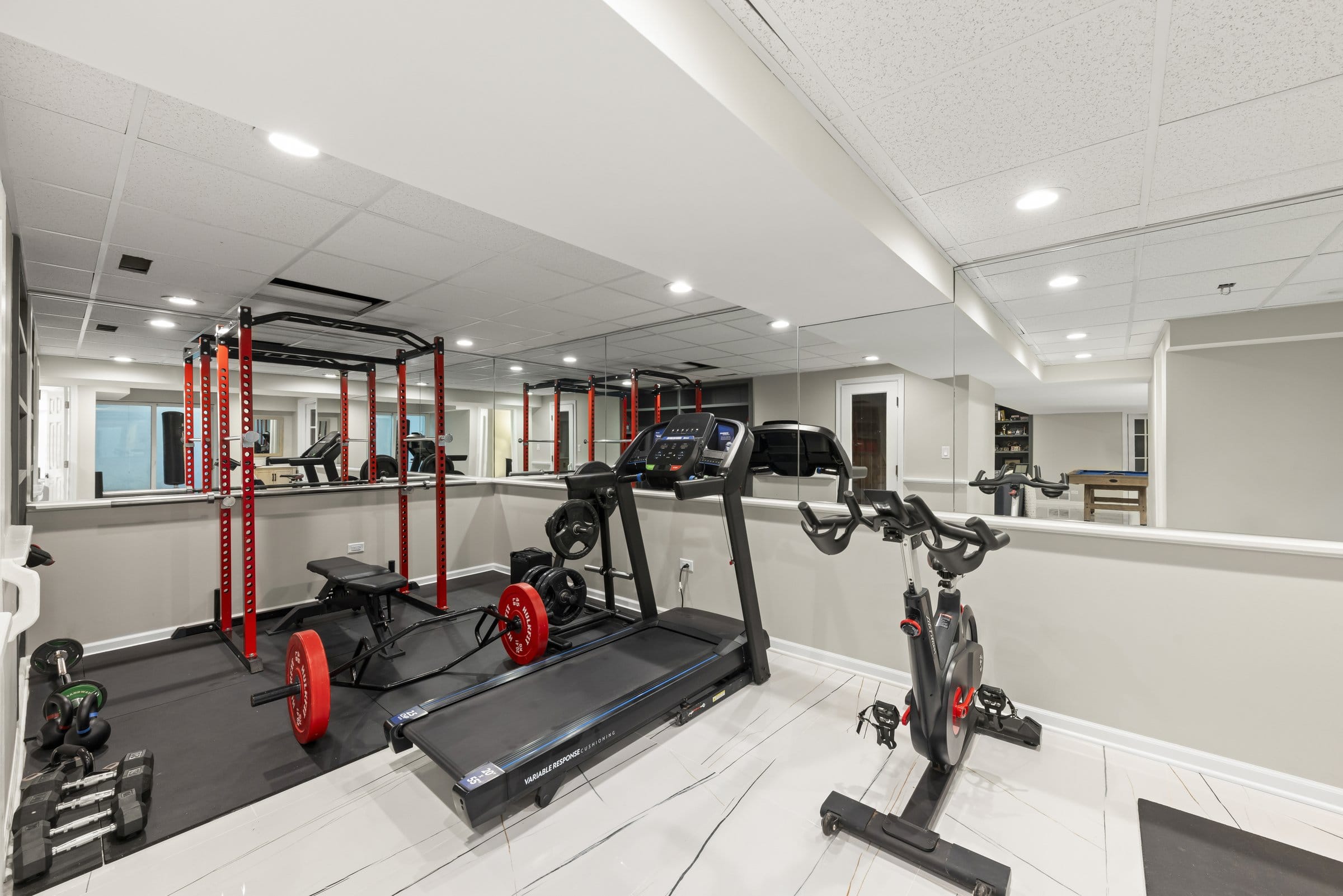 Naperville Luxury Home for Sale: 23W735 Hobson Road, a 2.65-Acre Estate with Indoor Pool and Tennis Courts 16 Lower level exercise room with power rack, treadmill and mirrored wall in this Naperville home