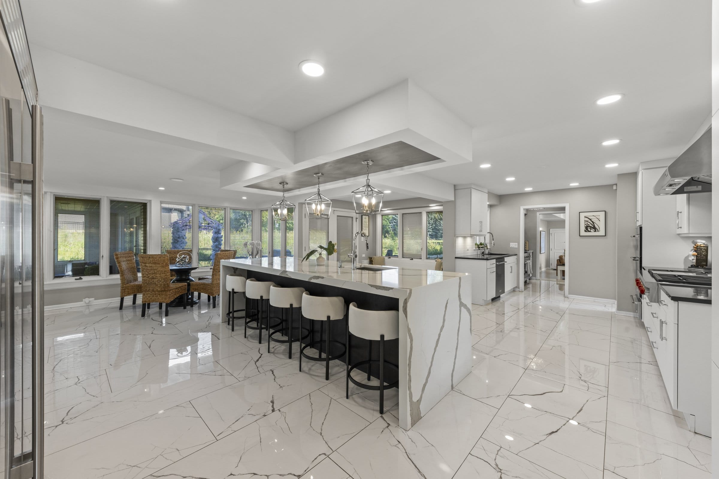 Naperville Luxury Home for Sale: 23W735 Hobson Road, a 2.65-Acre Estate with Indoor Pool and Tennis Courts 11 New main kitchen with waterfall marble island and bar seating at this Naperville luxury home