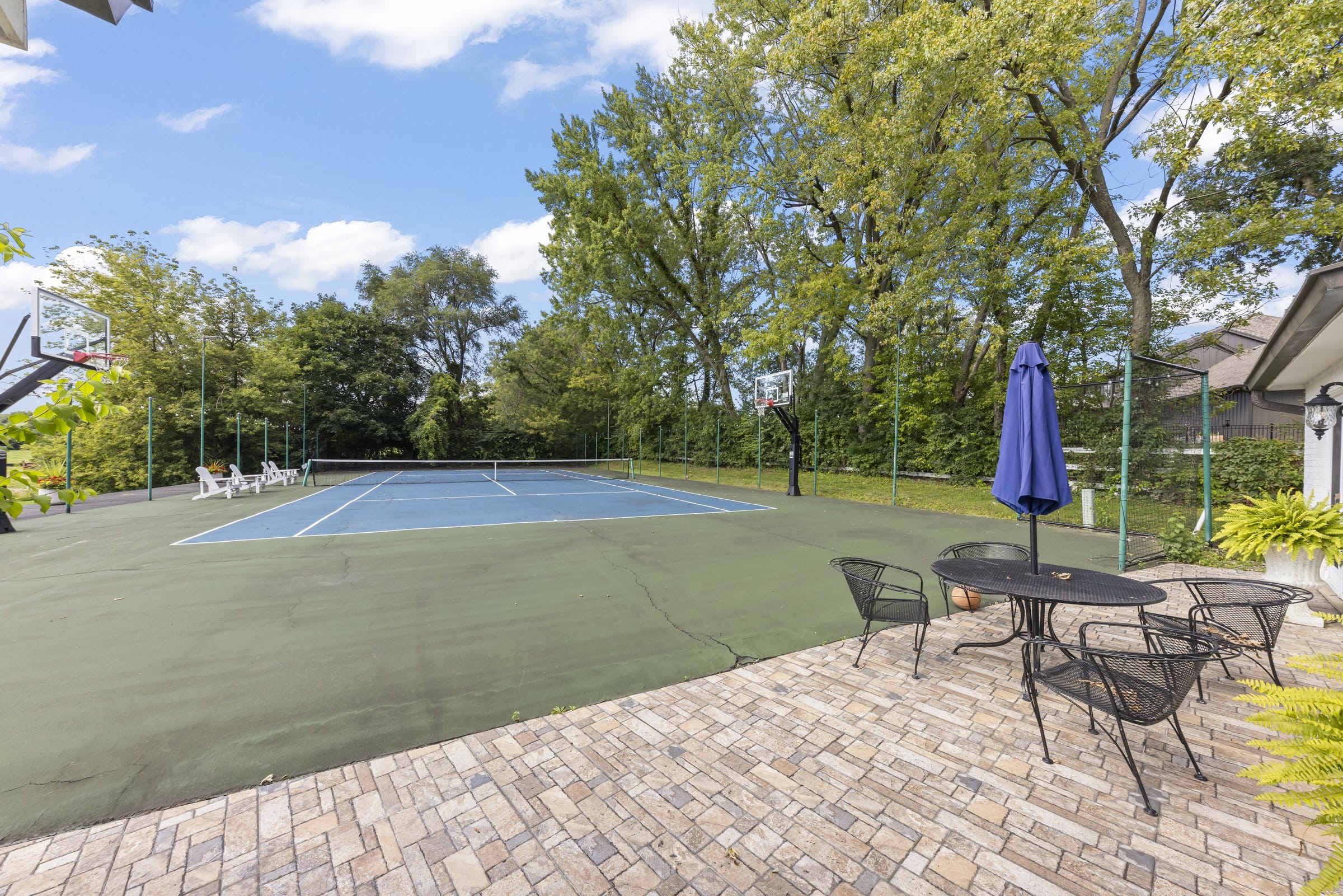 Naperville Luxury Home for Sale: 23W735 Hobson Road, a 2.65-Acre Estate with Indoor Pool and Tennis Courts 4 Renovated tennis and pickleball court with basketball hoops at 23W735 Hobson Rd Naperville