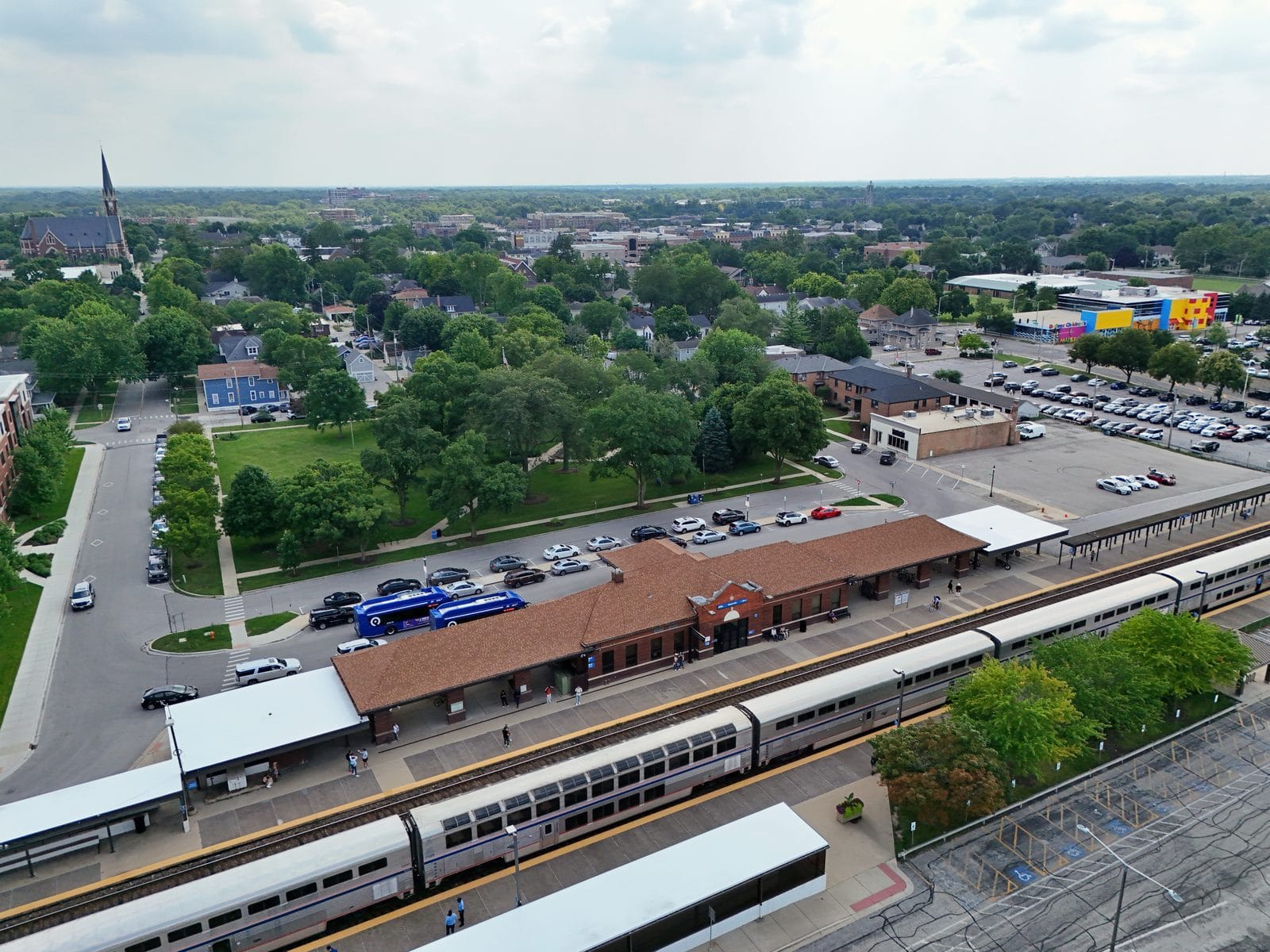 Naperville Metra Station, Aerial View of the Downtown Commuter Hub Aerial view of the Naperville Metra station with a commuter train at the downtown platform
