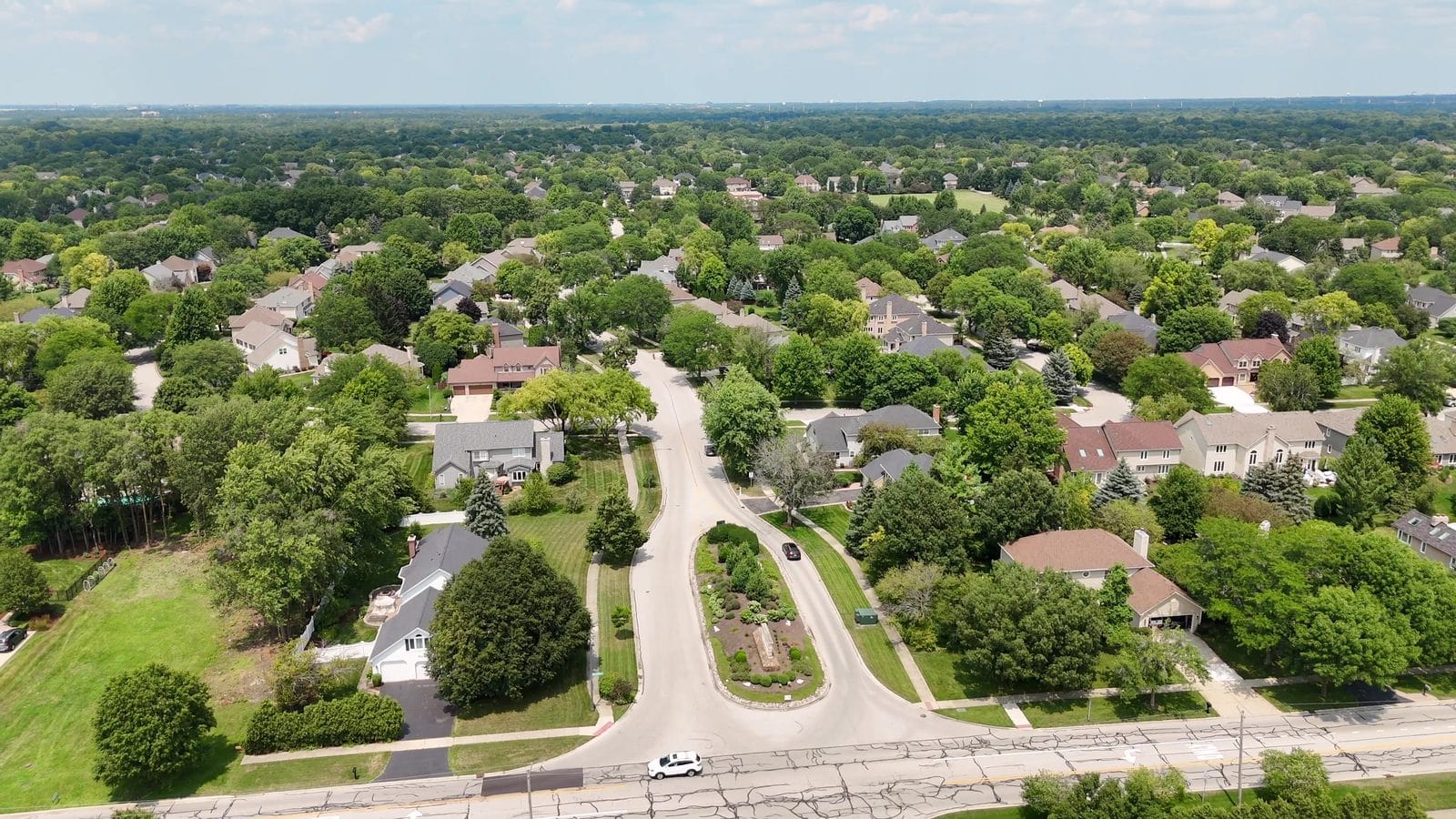 Naperville permit history before selling: aerial of Knoch Knolls homes along a curving street