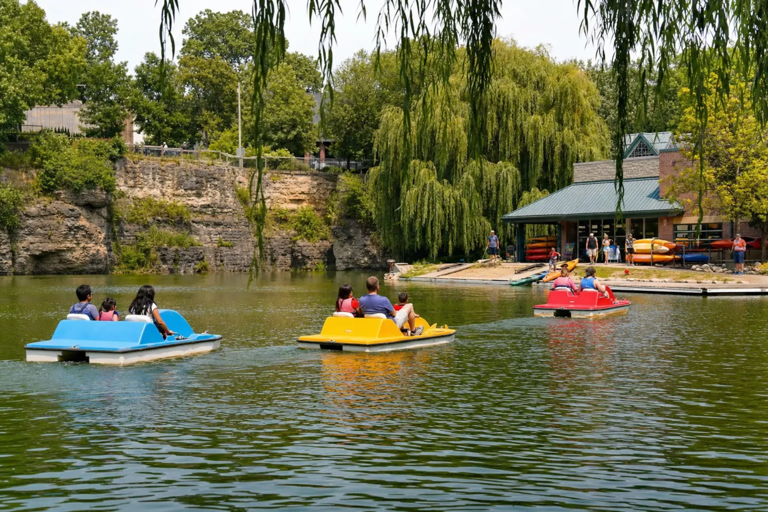 Families pedaling paddleboats on the Paddleboat Quarry along the Naperville Riverwalk