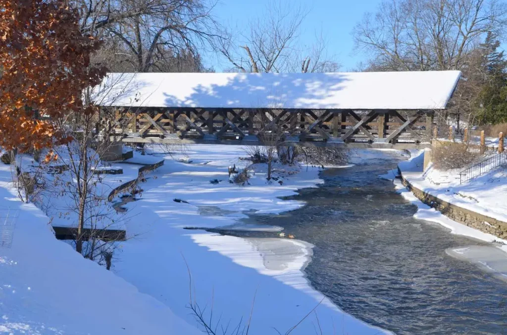 Snow covered winter scene along the Naperville Riverwalk in Illinois