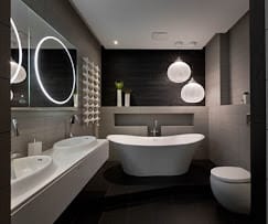 Modern bathroom with freestanding tub, sinks, toilet, and plumbing fixtures for Paul the Plumber services in the Naperville area.