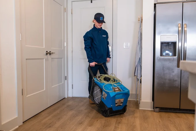 RestoPros of Chicagoland West technician using restoration equipment for water damage cleanup near Naperville Illinois