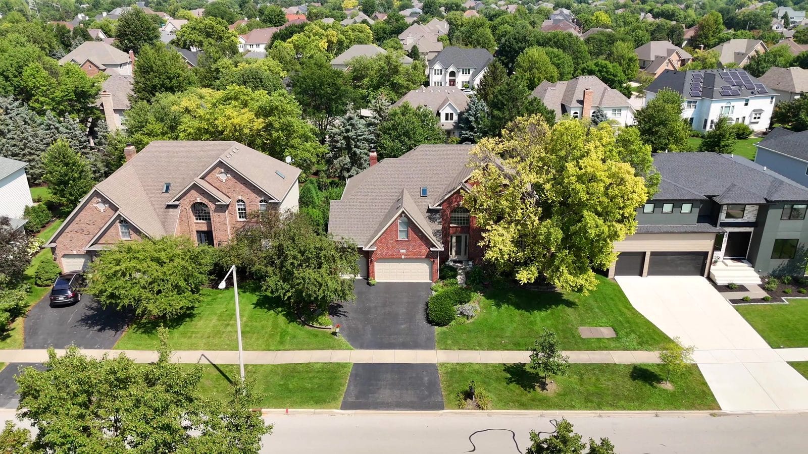 Selling a House With a Lien in Naperville: HELOCs, Payoffs, Releases 1 Selling a house with a lien: aerial of Naperville brick and modern two-story homes