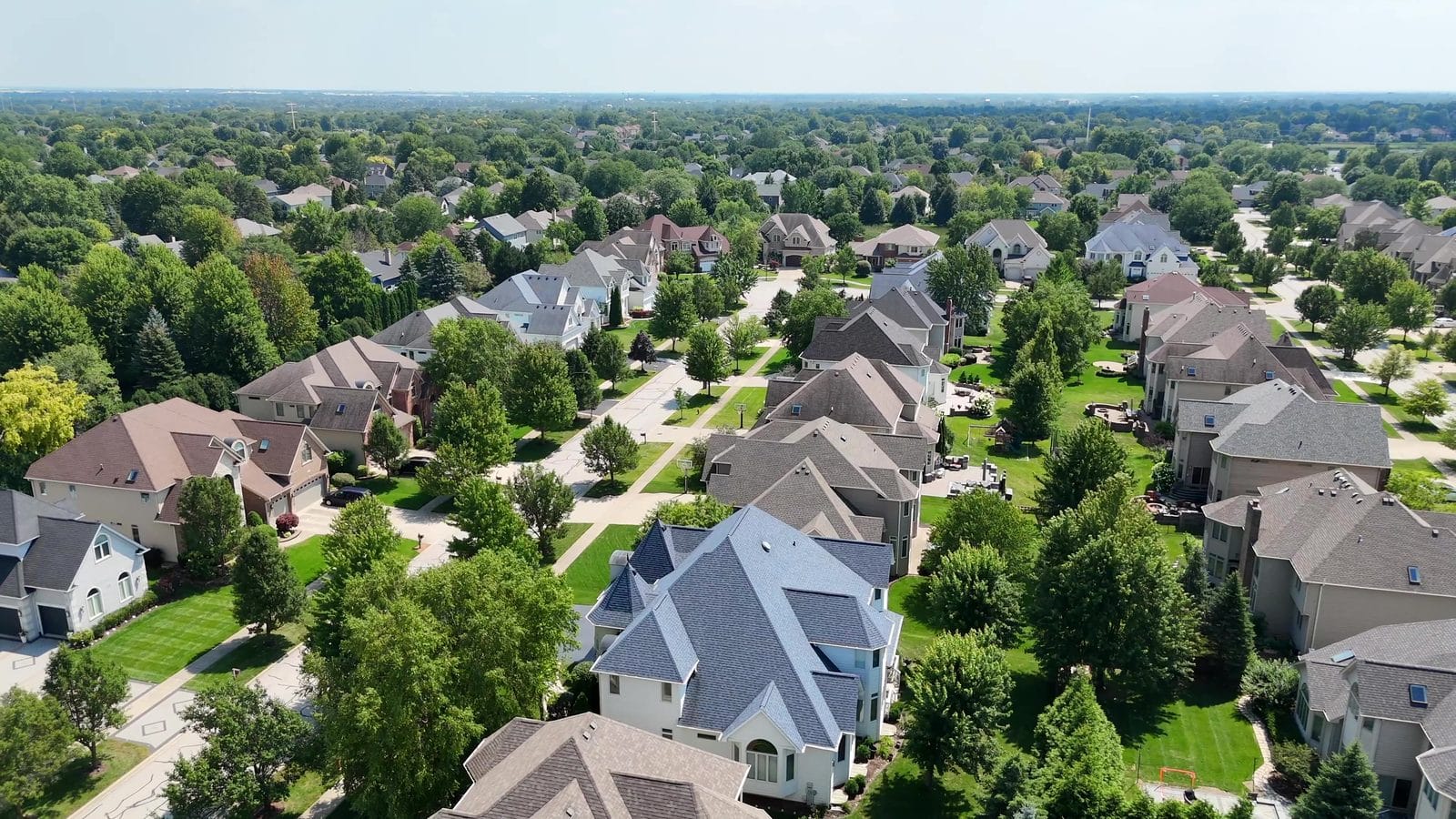 Selling a House With a Lien in Naperville: HELOCs, Payoffs, Releases 2 Selling a house with a HELOC: aerial of Naperville two-story homes on a tree-lined street