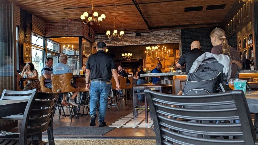 Guests dine inside The George in Naperville, Illinois, featuring a lively bar and dining room atmosphere in a downtown Naperville restaurant setting