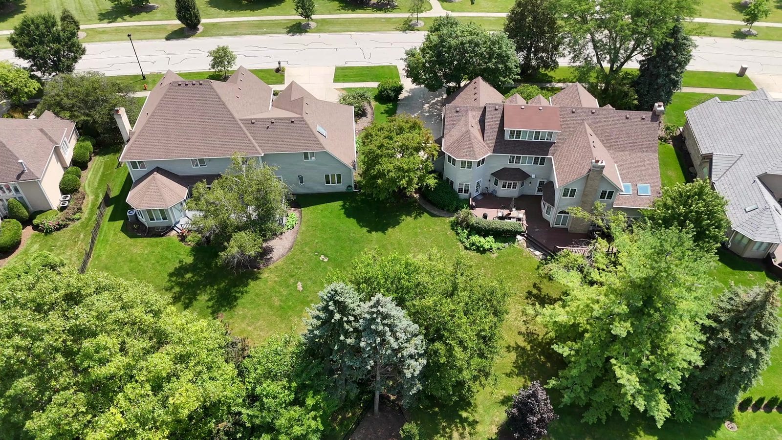 Buying a Home in Unincorporated Naperville: Outside the City Limits 3 Aerial of two two-story homes with backyards and trees, illustrating an unincorporated Naperville pre-offer checklist
