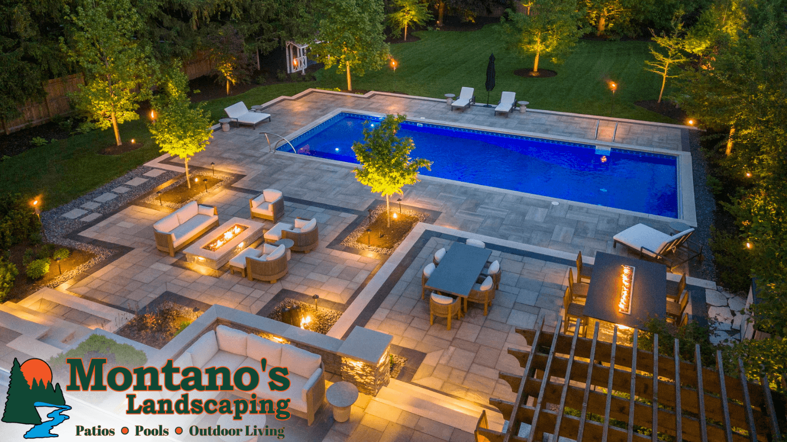 Dusk aerial of a Naperville pool patio with paver decking, fire features, and landscape lighting by Montano's Landscaping