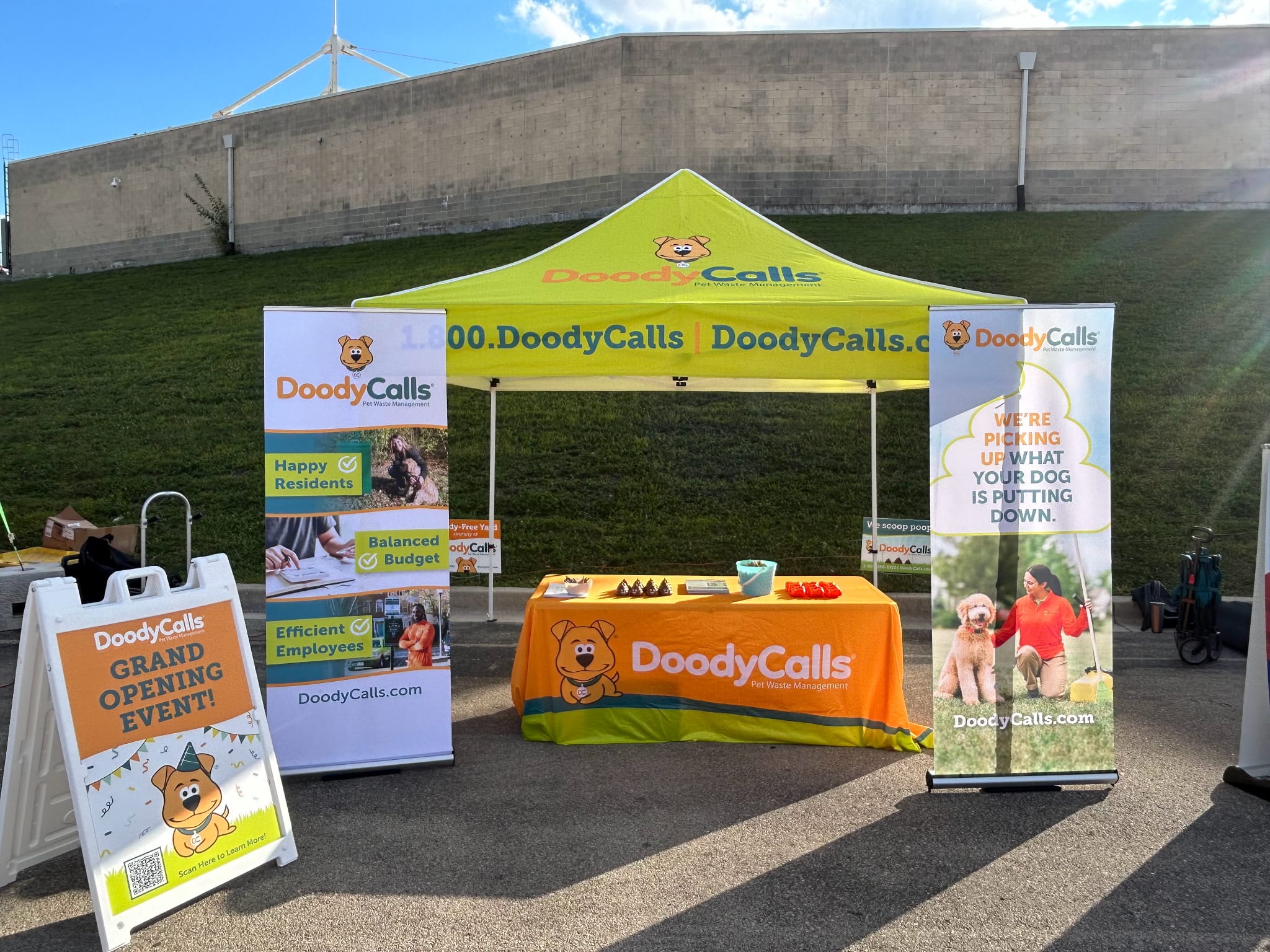 DoodyCalls Chicagoland promotional tent and event display showcasing pet waste management services in Naperville, Illinois.