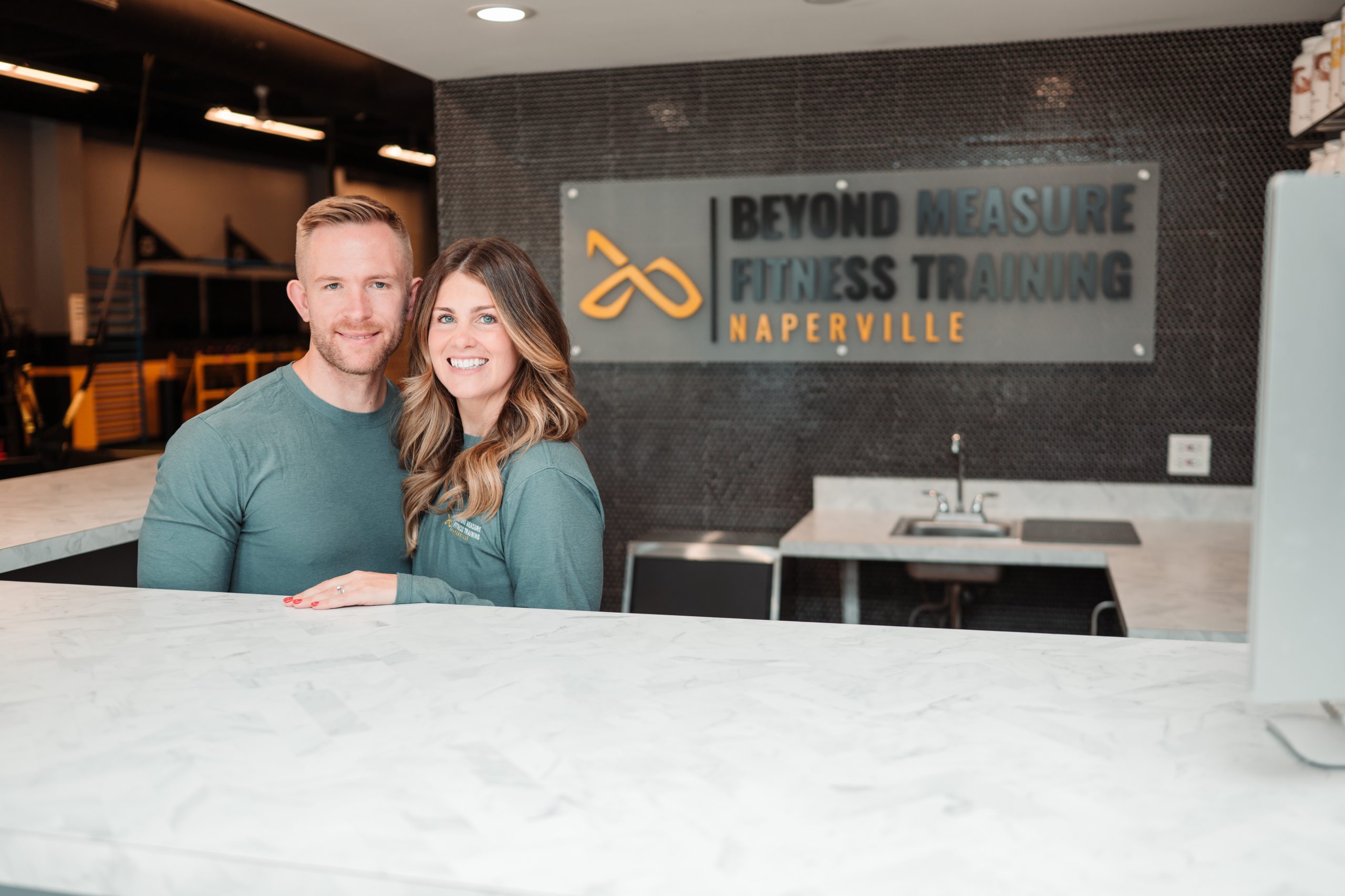 Owners of Beyond Measure Fitness Training standing inside their Naperville fitness facility.