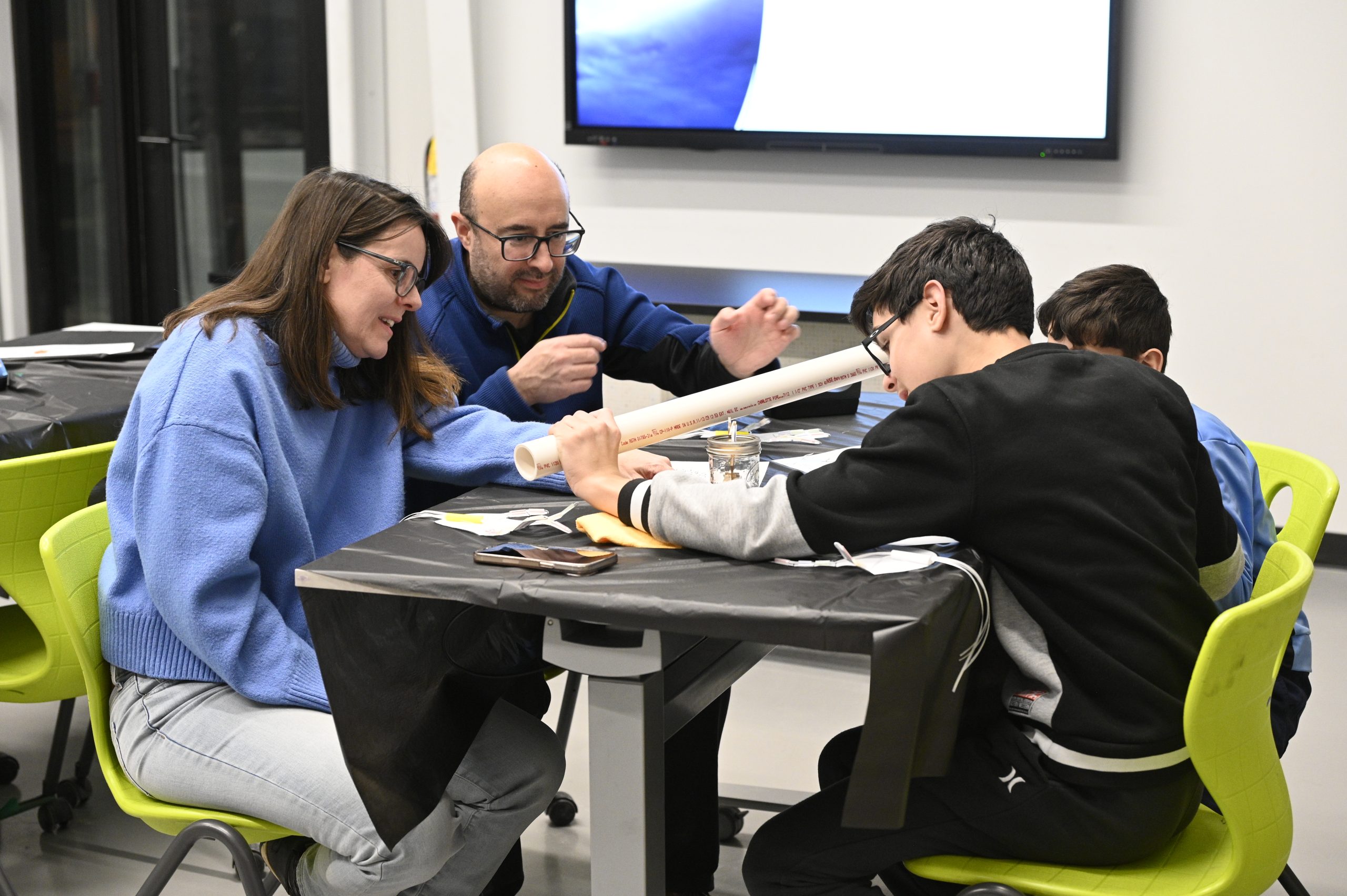 Families participating in a hands-on educational activity at Naper Settlement in Naperville, Illinois.
