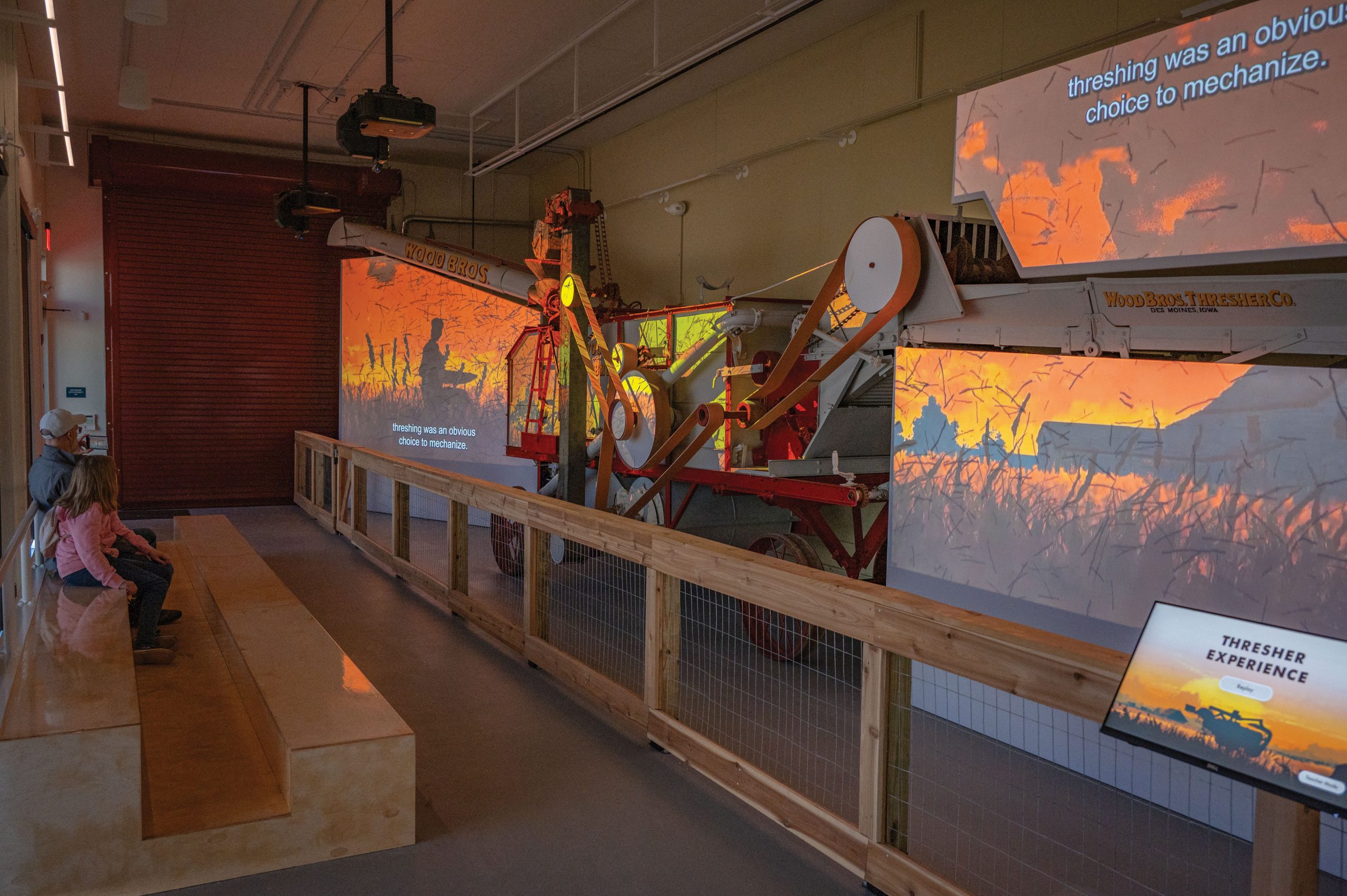 Historic agricultural machinery displayed in the Thresher Experience exhibit at Naper Settlement in Naperville, Illinois.