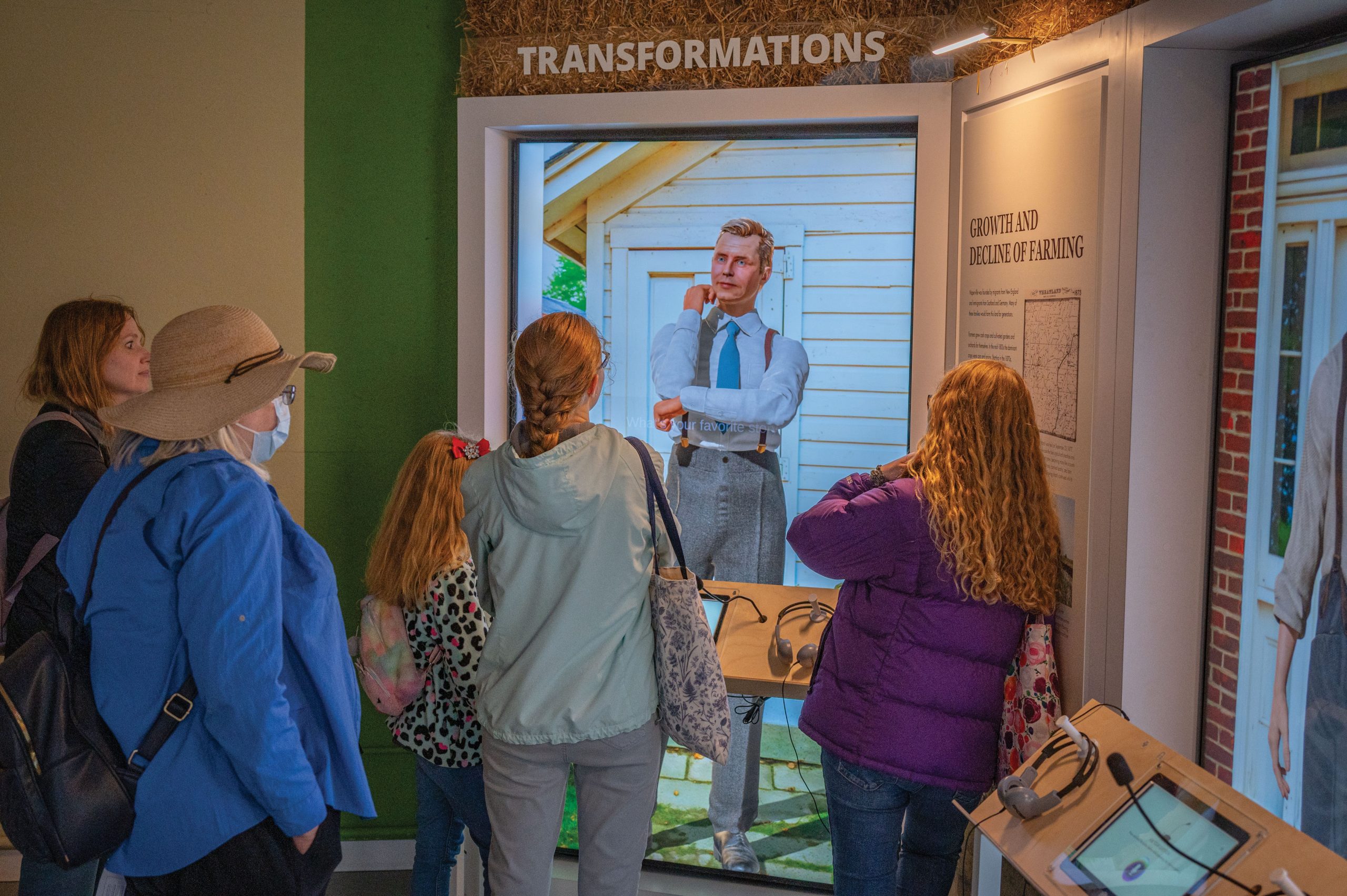 Visitors interacting with a digital historical presentation at Naper Settlement in Naperville, Illinois.