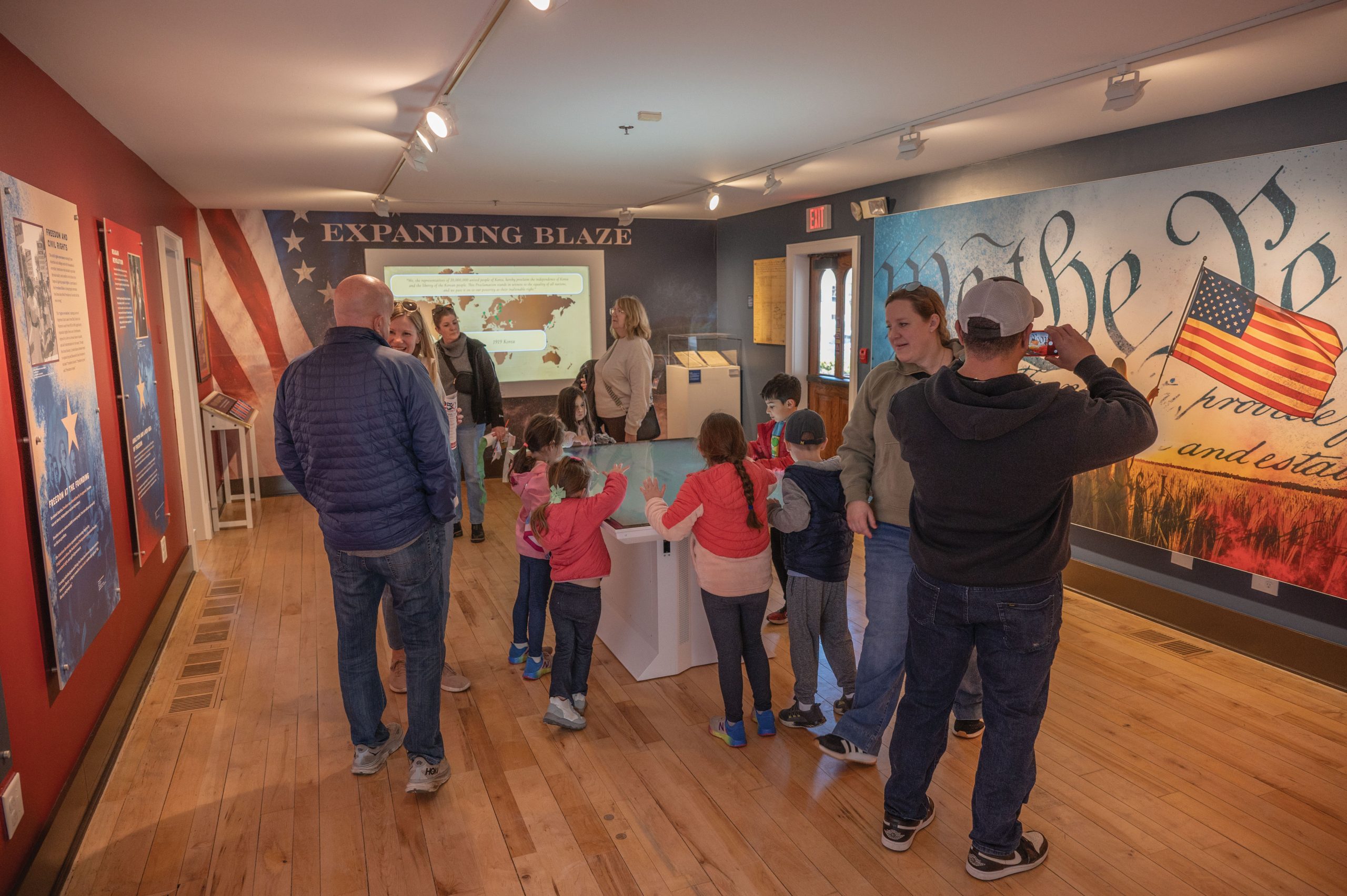 Families exploring interactive exhibits inside Naper Settlement in Naperville, Illinois.