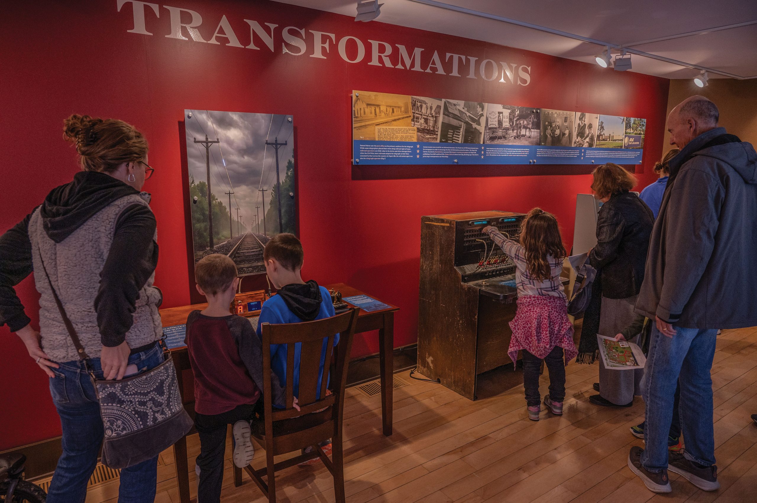 Visitors exploring the Transformations exhibit at Naper Settlement museum in Naperville, Illinois.